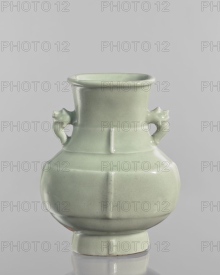 Vase; celadon-glazed Chinese ceramic decorative vessel in Qianlong style Qing dynasty, 1736–1795. Decoration with vertical, plastic, narrow stripes on the foot, body, and neck. Height 20.5 cm; width 16.4 cm; depth 6 cm. Maker and exact, A celadon-green glazed ceramic vase with a rounded, bulbous body tapering to a narrower neck and a flared rim, featuring a pair of small sculpted handles shaped like stylized animal heads on opposite sides, subtle vertical and horizontal ridges dividing the surface into panel-like sections, and a short stepped foot; the glaze shows variations of pale green and light mint tones with glossy reflections against a neutral gray background.
