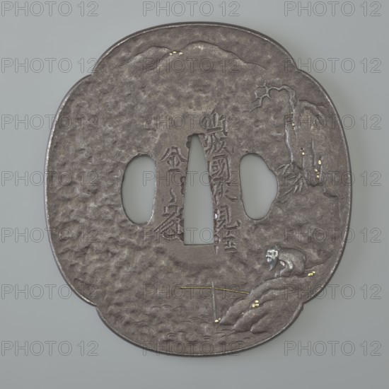 Crossguard tsuba, Kaneie,  school craftsman author. Japanese art, Japanese culture, Edo 1603–1868. Weapons; melee weapons; swords; katana; sword crossguards. Landscape motifs: rocks, mokkô, bamboos, trees, fishermen, mountains, moons. Tsuba in the shape of a quatrefoil mokkô gata with a slightly raised edge uchi kaeshi, ryôhitsu ana, textured surface ishime ji. Decorated in low relief hirabori with a landscape motif showing a fisherman sitting on the water's edge under a cliff and the moon emerging from behind distant hills visible at the top of the crossguard. Signed. 18th century Edo period, 1603–1868. Japan; Fushimi, Yamashiro. Tsuba. Height 8.5 cm; width 7.8 cm; depth 0.4 cm., A roughly oval metallic object with a textured gray surface and a few small shiny gold accents, featuring three irregular cutouts near its center; a few raised carved details form a scene with a reclining figure on the lower right rendered in gray and white tones, a few thin gold lines and dots near the lower...