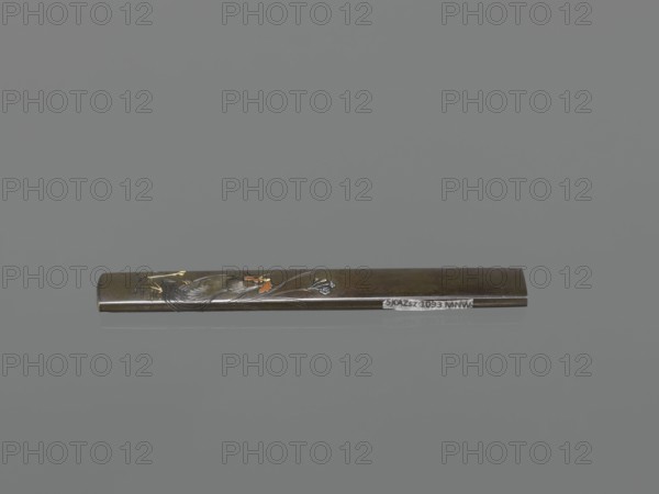 Knife handle kozuka, Suiyôdô, Toshimasa craftsman, Japanese art, Japanese culture, Edo 1603–1868, weapons, bladed weapons, swords, katana, kozuka, flowers, roosters iconography, 19th century Edo period, Japan, height 9.6 cm, width 1.4 cm, A long slender rectangular metallic object placed horizontally against a plain gray background, showing decorative engraved and inlaid imagery including a bird motif with visible orange and yellow accents and flowing engraved lines in silver tones, the metal surface appearing dark bronze to brown with subtle reflective highlights and a small area of contrast in a lighter metallic shade.