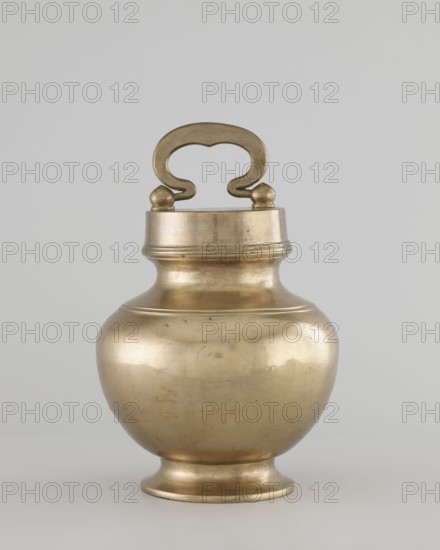 Teapot, gift, art of Southeast Asia, Southeast Asia culture, 19th/20th century, Burma Myanmar, vessel, container, height 22.0 cm, diameter 14.3 cm, A metallic vessel with a rounded, bulbous body tapering to a short pedestal base and a narrow neck topped by a fitted lid with a decorative handle; the handle is ornate with a curved, almost cloud-like shape and is attached to the lid by two rounded knobs. The surface of the vessel is smooth with subtle dents and small imperfections visible, and the overall color is a warm brass tone with areas of slightly darker patina and faint highlights that reflect light. The background is a neutral light gray.