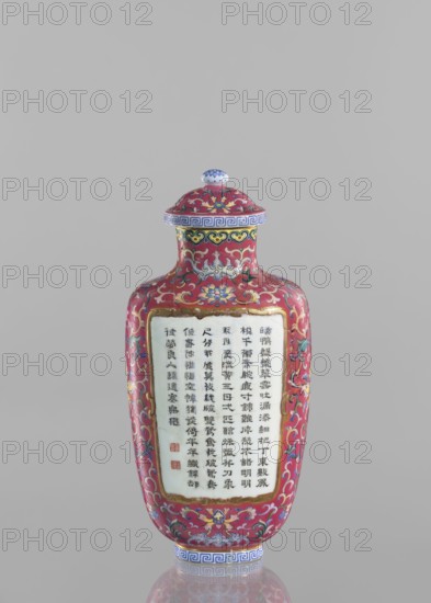 Vase with lid; maker, Chinese; Qing dynasty, Qianlong period 1736–1795; colored porcelain; flattened vase form; height 22.7 cm, width 10.7 cm, weight 0.65 kg; decoration: lotus tendril ornament and inscribed poems., A decorative bottle with a rounded shoulder and fitted lid sits against a plain light gray background; the bottle is predominantly deep red with elaborate floral and scrolling patterns in colors including blue, yellow, green, white, pink, and gold; the lid is decorated with matching motifs and a small white finial with blue detailing, and the rim and base feature a blue-and-white geometric border; a central rectangular panel of pale white is set on the front surface, bordered in gold and surrounded by the red patterned ground; the overall surface has a glossy finish and symmetrical ornamentation with floral medallions and curling foliage.
