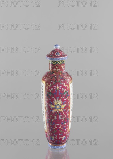 Vase with lid;, Gift; Chinese art; Chinese culture; Qing dynasty 1644–1911, Qianlong period 1736–1795. Ceramics: colored porcelain with lid; flattened vase form; lotus tendril ornament; inscribed poems/poetry. Vessel, height 22.7 cm, width 10.7 cm, weight 0.65 kg., A tall, slender decorative vessel with a rounded lid sits against a plain gray background; the vessel is predominantly deep pink with ornate floral and scrollwork patterns in yellow, blue, green, white, and gold, and it has a band of blue decorative motif near the base and rim, plus a small rounded finial on the lid that shows blue and white.