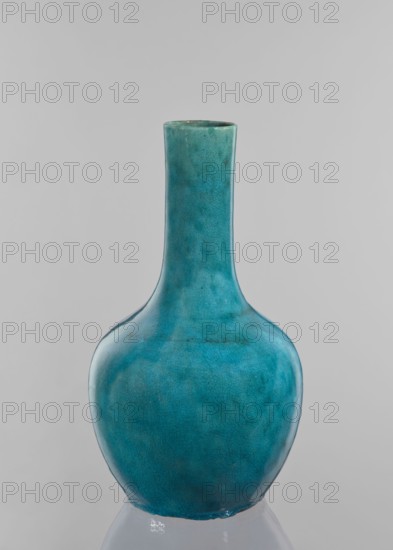 Vase-bottle; maker, cracklework decoration; uniform blue-green glaze with fine cracklework; decorative vessel/bottle; 19th century; China; height 33 cm, diameter 18 cm., A tall vase with a long narrow neck and a rounded body finished in a mottled turquoise glaze showing subtle variations and crackle texture against a pale gray background.