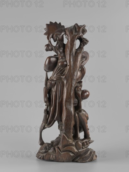 Mythical figure, unknown sculptor, Chinese and Japanese art and culture influences; pines; fantastical beasts; Qing dynasty 1644–1911; fantasy animals, mythology, unicorns iconography; 2nd half of the 19th century; possibly China or Japan as place of origin; sculpture figurine; height 46 cm., A carved wooden sculpture shown against a neutral gray background, featuring a tall organic form with flowing drapery and rounded bulbous shapes intertwined with a textured vertical element resembling bark; the surface displays a rich dark brown patina with lighter brown highlights on raised areas and subtle reddish-brown tones in the grain; the base is irregular and carved to suggest undulating rock or roots, and the overall piece has smooth polished areas alongside carved, faceted details.