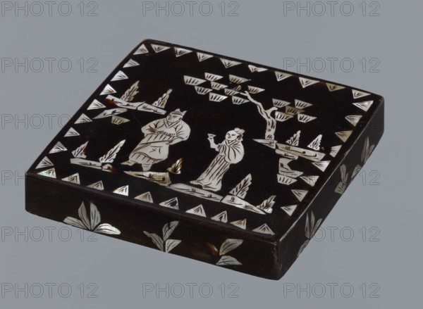 Lid, figural scenes, Chinese art, Chinese culture, Qing 1644–1911, trees, pines; lid made of black lacquer inlaid with mother-of-pearl, 19th century, China; height 1.7 cm, width 11.4 cm, depth 11.4 cm., A dark rectangular box with a glossy black surface features inlaid pale, iridescent shapes forming a decorative scene on its lid and sides; the lid shows a pair of stylized human figures standing among stylized trees and foliage, with triangular and leaf-like inlays bordering the scene, and the sides display repeated leaf motifs. The visible colors are black, white with a pearly iridescence, and small areas of brownish tones.