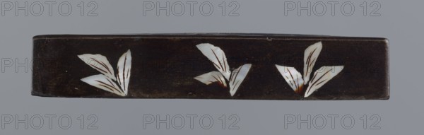 Lid, figural scenes, Chinese art, Chinese culture, Qing 1644–1911, trees, pines, lid made of black lacquer inlaid with mother-of-pearl, 19th century, China, height 1.7 cm, width 11.4 cm, depth 11.4 cm, A long rectangular dark brown object with a smooth surface displayed against a gray background, decorated along its front with a few stylized white leaf shapes that have fine brown lines and small areas of brownish-orange near their bases, the leaves grouped into a few clusters spaced across the length of the object.