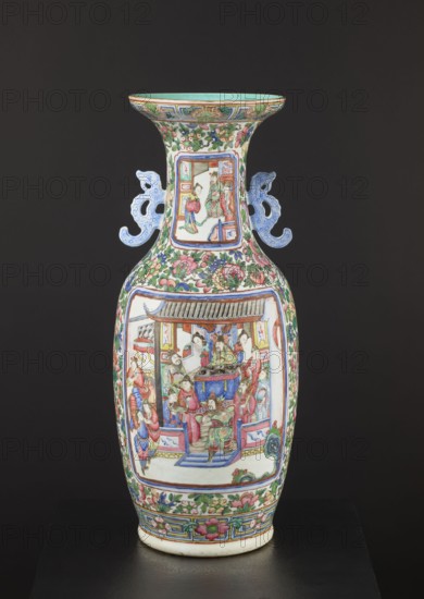 Cantonese vase, Canton China, 19th century. Colored porcelain ovoid vessel with thin neck and two side handles; rib with an upwardly curled edge and plastically separated foot. Thick gray-bodied porcelain with white glaze tinged gray. Decoration in overglaze enamel paints two shades of green, blue, yellow, red, pink, black, overglaze iron red and gilding. Two reserves on body and neck each with figural court scenes; backgrounds with flowers, birds, butterflies, and fruit; floral decorative motifs. Height 63 cm, diameter 28 cm., A tall porcelain vase with a flared rim and a narrow neck widening into a bulbous body stands against a dark background, decorated with ornate painted panels and floral motifs; the vase displays a palette of green, pink, blue, red, white, turquoise, and gold tones. A group of painted figures appears within framed scenes on the neck and main body, dressed in colorful robes and gathered around architectural elements, while a few floral sprays and scrolling foliage...