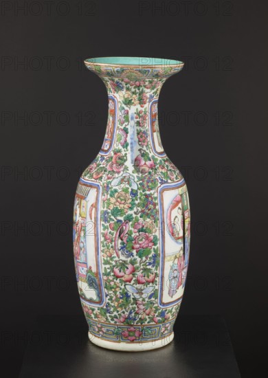Cantonese vase, Canton China, Chinese art; ovoid body with thin neck and two side handles, rib with upwardly curled edge, plastically separated foot. Decoration: two reserved figural court/figurative scenes on body and neck with background flowers, birds, butterflies and fruit. Thick porcelain body with gray paste and white glaze with grayish tint. Painted with overglaze enamel paints in two shades of green, blue, yellow, red, pink, black; overglaze iron red and gilding. 19th century, China; vessel; height 63 cm, diameter 28 cm., A tall, curving porcelain vase with a flared rim sits against a dark background; the vase is covered in dense floral and figural painted decoration in colors including pink, green, blue, red, turquoise, yellow, and white, with accents of darker outlines; the main body shows a profusion of flowers, leaves, fruit, and birds interspersed with framed panels containing scenes with human figures, all rendered in a fine, detailed style; the rim interior is a turquois...