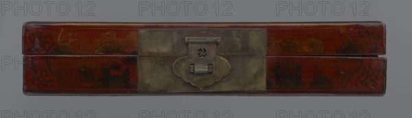 Box, Chinese, Qing 1644–1911, early 20th century. Lacquered container with staffage: boats, figural scenes of scholars and sages, landscape motifs, defensive walls architectural, swastikas. Materials/format: box; height 33.7 cm, width 19.5 cm, depth 6.7 cm., A rectangular box with a hinged lid viewed from the front, featuring a central metal clasp with a patinated surface and a decorative cloud-shaped plate; the box surface is predominantly red with areas of darker red and brown, showing painted dark brown and black ornamental patterns and stylized landscape or cloud motifs in muted gold and brown tones, and the background is a flat gray.