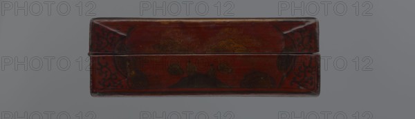 Box, Chinese, Qing dynasty 1644–1911, early 20th century; materials and function: container; dimensions: height 33.7 cm, width 19.5 cm, depth 6.7 cm. Decoration: landscape motifs with boats, figural scenes of scholars/sages, defensive walls architectural, staffage; includes swastikas. Style: Qing., A rectangular wooden box with a hinged lid is shown from the front; the surface is a deep red-brown lacquer with darker brown and black decorative motifs, including a pair of small human-like figures seated on a mound flanked by stylized cloud or floral shapes, and ornate corner scrollwork; the finish shows subtle wear and lighter brown highlights where the lacquer has aged, and the background behind the box is a neutral grey.