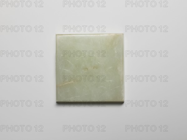 Plaque, Chinese, Qing 1644–1911; pale green jadeite plaque with engraved landscape motifs depicting fishermen and a rock; buttonholes on the reverse; 19th century; height 5.1 cm, width 5.1 cm, thickness 0.8 cm., A square, flat object with a pale green surface sits centered against a light gray background, showing subtle variations of green and faint pale yellow tones; the surface has a smooth, slightly translucent appearance with thin, shallow scratches and carved lines forming a faint pattern, and the object's edges are slightly rounded with a small shadow beneath giving a sense of depth.