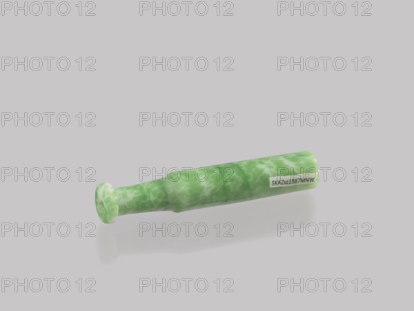 Cigarillo, Chinese, Qing dynasty 1644–1911, 19th century. Cast glass, green and white; smoking tobacco implement. Height 7.9 cm, diameter 1.35 cm; place of origin: China., A small cylindrical object with a flared end lies on a pale gray surface, showing a mottled pattern of green and lighter green across its surface and casting a soft shadow beneath it.