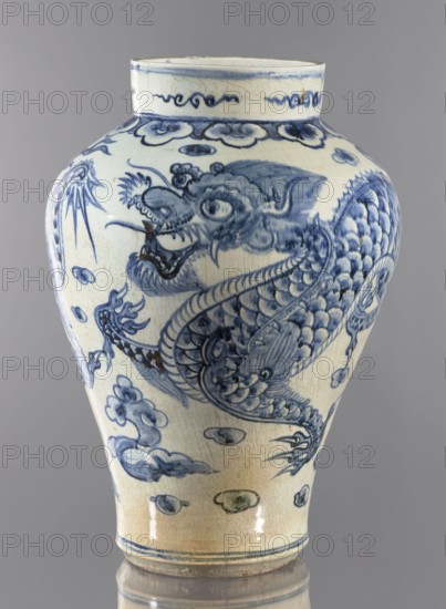 Vase, Ovoid vase with a long neck, maebyeong type Chinese: mei-ping. Korean, Joseon 1392–1897, 18th century. Decoration: two dragons among clouds. Material: vessel. Dimensions: height 46.0 cm, width 32.0 cm, weight 8.0 kg., A ceramic vase with a rounded shoulder and narrow base standing against a gray background, decorated in blue on a pale cream body; the visible surface shows a large stylized dragon motif with scales, claws, a snarling head, and flowing whiskers rendered in varying shades of blue, surrounded by cloud-like forms and decorative bands near the rim and base; the glaze shows fine crackling and areas of slightly darker discoloration, and the overall colors visible are blue, cream, gray, and small patches of brown.