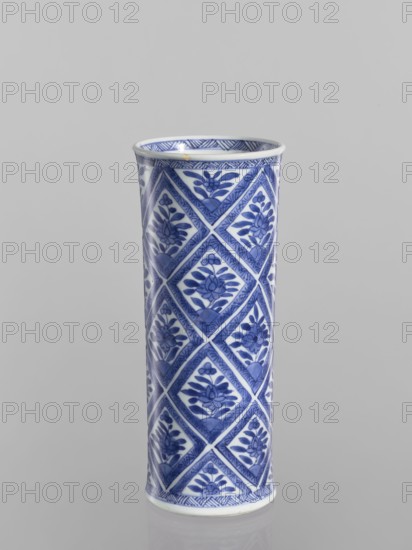 Vase, Chinese, blue-and-white porcelain, ceramics; cylindrical vessel with geometric and floral ornaments including rhombuses; 18th century China; height 23.2 cm, diameter 9.6 cm., A tall cylindrical ceramic vase with a glossy finish, decorated in a repeating geometric pattern of diamond-shaped panels each containing stylized floral motifs; the visible colors are blue and white.