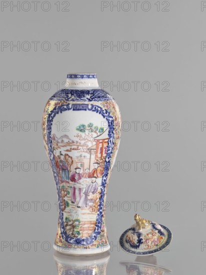 Vase with a lid, Chinese, ceramics, colored porcelain, figurative scenes, lids, geometric ornaments, plant ornaments, lions, floral decorations, genre scenes against a landscape background, provenance unknown. The lid is topped with a modeled seated lion. Decoration: geometric and plant ornament around the neck; two large reserves bordered with plant ornament filled with figural scenes in a landscape, two smaller reserves with figures in a landscape; background of twigs with flowers on a gold ornamental ground. White glaze, underglaze painted with cobalt, overglaze enamels in sepia, black, iron red, and gold. 18th century, China, vessel, height 28 cm., A tall porcelain vase and a matching lid rest against a plain gray background, the vase standing upright and the lid placed on its side nearby. The vase has a bulbous upper body tapering to a narrower base and is predominantly white with extensive blue decorative borders framing painted scenes. Within the framed panels are figurative sce...