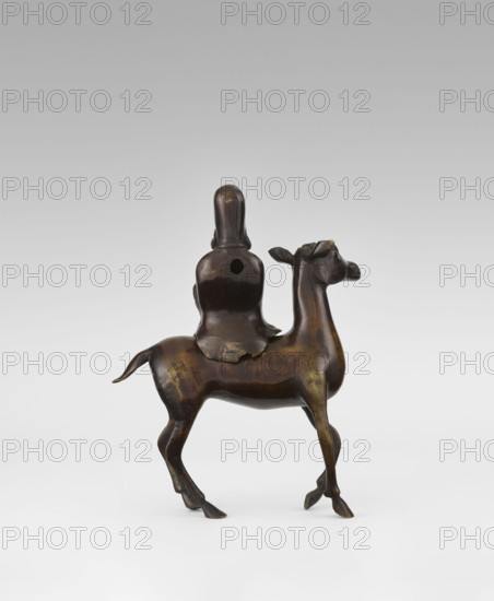 Shoulao on a deer - incense burner, unknown sculptor, deer, figurines, Chinese art, Chinese culture, incense burner depicting Shoulao Shouxing, Taoist sage of longevity, Qing dynasty 1644–1911, 18th century, China, sculpture, height 27.5 cm, A small sculptural object depicting a rider seated on an animal with slender legs and a raised head, all rendered in a dark brown material with areas of lighter brown highlights and a subtle golden sheen; the rider has a smooth, rounded head and a cloak-like form draping over the animal's back, and the animal shows defined limbs, a short tail, and slightly turned head with small ear forms.
