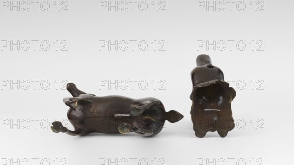 Shoulao on a deer - incense burner, deer, Chinese art, Chinese culture, Taoism, incense burner, Shouxing iconography, sages, Qing dynasty 1644–1911, 18th century, China, sculpture, height 23.7 cm, A dark brown glossy ceramic animal figure lies on its side next to an upright hollow base of a similar dark brown glossy object, both resting on a white surface against a white background; the lying figure shows a few greenish-blue patina spots on its feet and underside, and both objects display some worn areas with lighter brown and muted gold tones.
