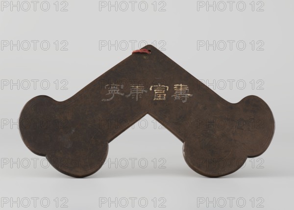 Gong, Qing dynasty 1644–1911; percussion idiophone; silver inlay; plant ornaments and tendrils; Chinese calligraphy inscription; 18th century ; China; height 15.0 cm, width 28.0 cm; musical instrument., A dark brown object with a symmetrical, angular shape and rounded ends sits against a pale gray background; the surface shows subtle lighter brown and almost black variations and faint swirling etched patterns, and a short red cord loops through a hole at the top.