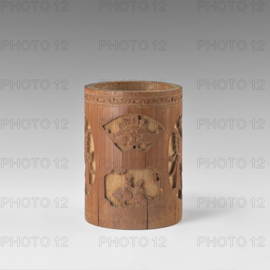 Brush vessel, Chinese, Qing dynasty 1644–1911, early 20th century. Ceramic container with bas-relief decoration of figural scenes in a landscape and images of birds; reserves with varied shapes. Height 16.4 cm; diameter 11.9 cm., A cylindrical carved wooden container stands upright on a light surface against a gradient gray background; the wood is a warm brown with visible grain and slightly darker carved details, and the interior shows a paler brown. The cylinder features carved decorative panels including a fan-shaped motif with raised floral or leaf forms, a rectangular recessed panel with a carved natural scene, and openwork vertical sections with curved carved elements on the sides. The top rim has a carved band of repeating leaf-like shapes in a slightly darker brown, and there are vertical seams and subtle cracks in the wood near the base. The overall colors visible are shades of brown, pale brown inside, light gray of the surface, and medium gray to darker gray in the backgroun...