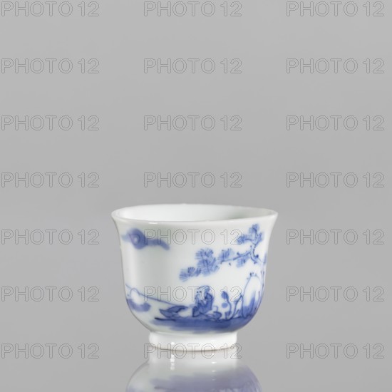 Bowl, 18th century Japan, blue-and-white porcelain vessel, height 3.8 cm, width 5.0 cm; decoration: fishermen and figures in a landscape; ceramics, Japanese art., A small white porcelain cup with blue painted decorations sits against a gray background; the cup has a slightly flared rim and a short foot, and shows a blue landscape scene with a tree, foliage, and a seated figure, with additional blue brushstrokes near the rim and along the base.