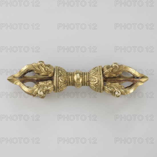 Vajra;, crafted; Tibetan; Buddhist art; Tibetan Buddhist art; vajra ritual object; 19th century, Tibet; ritual object; height 9.6 cm, width 3.0 cm, A symmetrical metallic object with a gold color centered against a light gray background, featuring a rounded central section with decorative ridges and embossed patterns, flanked by two ornate tapered ends that each form a pointed, open shape with scrolling, leaf-like motifs and textured edges, showing a few areas of darker, brownish discoloration along inner surfaces.