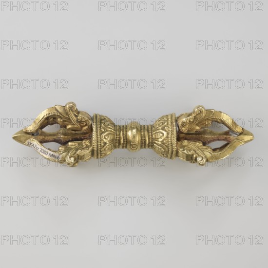 Vajra;, crafted; Tibetan; Buddhist art; Tibetan Buddhist art; vajras; ritual object; 19th century, Tibet; height 9.6 cm; width 3.0 cm, A small ornate metal object lies horizontally on a plain light gray background; the object is predominantly gold in color with areas of darker brownish metal visible in recessed sections and along inner surfaces. The object has a symmetrical double-ended shape with a central cylindrical segment decorated with raised beaded and floral-like patterns, flanked by two bulbous collars with intricate relief work and textured bands. Each end tapers into an open, petal-like form featuring curved, leaf-like scrolls and layered elements that create a sense of depth and shadow; the inner cavities show darker brown tones contrasted with the bright gold surfaces. The overall appearance is metallic and polished in places, with subtle variations between shiny gold highlights and matte golden areas.