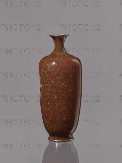 Vase with a narrow neck flaring at the spout; decoration on a brown-brick background. Kinseki vase, Japanese, Meiji period 19th–20th century, height 17.9 cm, diameter 7.0 cm., A tall, narrow ceramic vase with a flared neck and rounded shoulders, finished in a speckled reddish-brown glaze with visible flecks of gold and darker brown; the rim and base have a thin band of metallic color, and the vase casts a subtle reflection on the smooth gray surface beneath it against a plain light gray background.