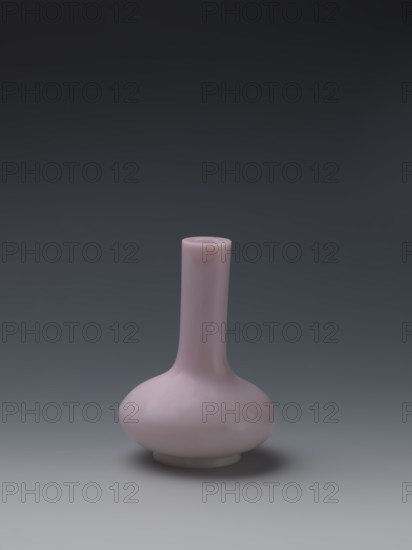 Vase, Chinese, Qing dynasty, Qianlong period 1736–1795. Flask of pale pink glass on a low ring foot with a straight long cylindrical neck. Vessel, height 13.6 cm, diameter 9.8 cm, weight 0.35 kg. Made in China, 1736–1795., A single smooth vase with a rounded bulbous base and a long narrow neck sits centered against a gradient background; the vase is a pale pink color with subtle glossy reflections, and the backdrop shifts from dark gray at the top to lighter gray near the bottom.