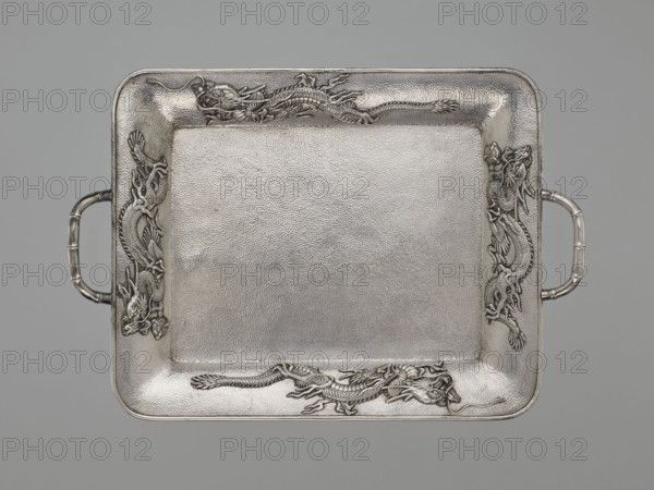 Tray, Japanese art, Japanese culture, dragons, Meiji 1868–1912, Japanese dragon motif, silver, bamboos, grained background decoration, early 20th century Meiji period, Japan, vessel, height 1.7 cm, width 30.8 cm, depth 21.2 cm, A rectangular metal tray with rounded corners and a textured surface, featuring a raised border with ornate dragon reliefs at each side and ends, and tube-shaped handles projecting from the shorter edges; the visible colors are silver and gray.