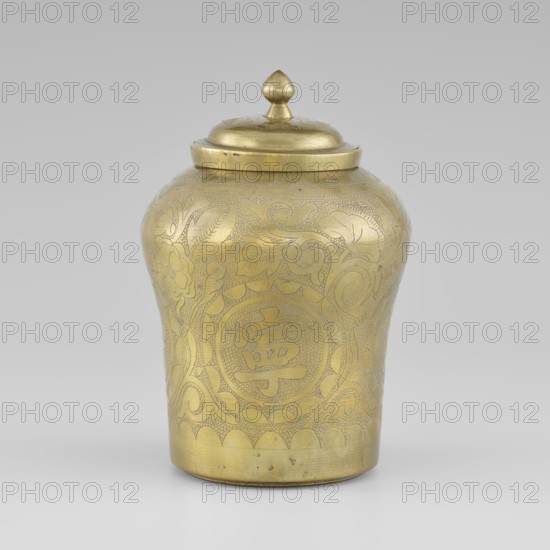 Tin with a lid, tin, early 20th century, Korea, container with widened top, height 15.0 cm, diameter 9.8 cm; ornamented with peonies; Korean art., A single metal container with a lid, rendered in a gold tone, sits against a neutral gray background; the container has a rounded, slightly tapered body with a domed lid topped by a small pointed finial, and its surface is decorated with engraved floral and foliate patterns and textured areas, showing a few darker spots and minor wear on the metal.