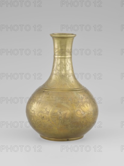 Vase — bottle; maker,  noted; Chinese art; Chinese culture; Qing dynasty 1644–1911; decorated with plant ornament: peonies; on a very low, ring-shaped foot; 19th century; China; vessel; height 20.9 cm; diameter 15.38 cm, A rounded metal vessel with a narrow neck and flared rim sits against a pale gray background, its surface showing a golden brass color with areas of slightly darker patina; the body features engraved decorative motifs including floral and foliate shapes and patterned bands, and the neck displays etched scallop-like designs and a banded collar, all rendered in the same golden tone with subtle variations in sheen.