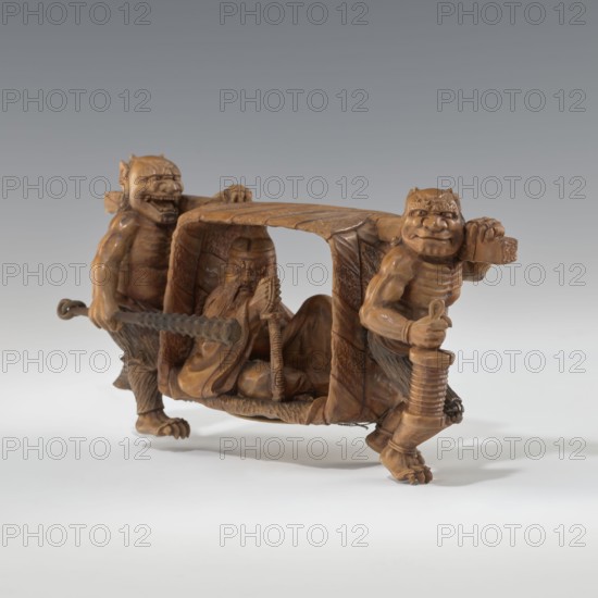 Okimono in the shape of Oni and Shôki; maker, ; Japanese art; Japanese; Meiji period 1868–1912; subject: mythology, demons, Shôki; early 20th century; Japan; sculpture okimono; height 9.1 cm, width 16.0 cm., A carved wooden scene shows a small carriage-like structure carried by two stout, humanoid figures with exaggerated facial features and muscular limbs, each holding parts of the carriage; inside the covered compartment sits a seated bearded figure with a solemn expression holding a long staff. The carving is predominantly brown with variations in warm wood tones and subtle darker brown shading; the background is a smooth gradient of gray transitioning to pale gray near the bottom, and the surface beneath the carving is a pale off-white.