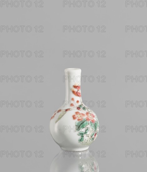 Bottle, very small ovoid bottle with a long, thin, straight neck. White glazed colored porcelain painted with enamel paints and black contour overglaze; unsigned. Floral decorations. 19th/20th century, China. Vessel; height 5.7 cm, diameter 3.5 cm., A small white ceramic vase with a narrow neck and bulbous base sits against a plain gray background, displaying painted floral motifs in shades of pink and red, green leaves, and subtle black outline details; the vase and its painted design are reflected faintly on the glossy surface beneath, and the overall color palette includes white, gray, pink, red, green, and black.