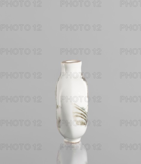 Flask - snuffbox in the shape of a pilgrim's bottle;, Circular, flattened shape with a short neck. Thick porcelain body, fine-grained dough with a greyish hue, bluish glaze, gilded rim. Colored porcelain with figural scenes, images of birds, landscape motifs; moon bottle form; Qing style Qing dynasty, 1644–1911. 19th century, China. Function: vessel/snuffbox. Dimensions: height 7.8 cm, width 5.1 cm., A small glossy white ceramic vase with a narrow neck and rounded body stands upright on a reflective surface, showing delicate painted botanical motifs in muted green and soft brown tones on its sides, with faint hints of pink and pale beige in the painted areas and a thin rim of light beige around the mouth; the background is a uniform light gray.
