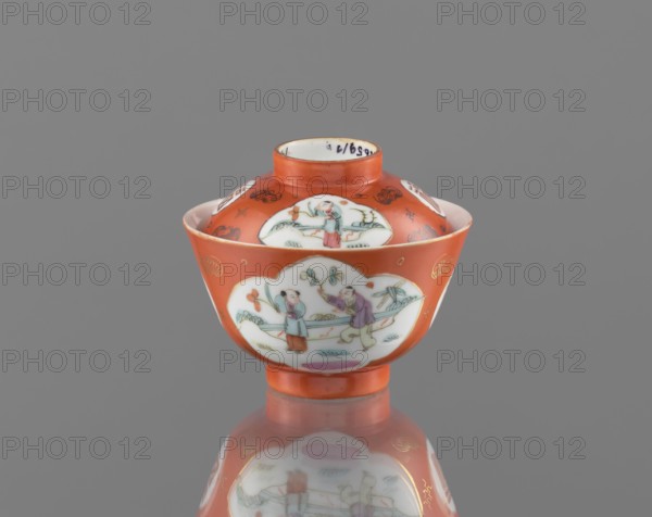 Bowl with a lid, maker, porcelain; colored; Qing dynasty, Tongzhi period 1862–1874; Chinese; decorated with loosely placed bats and swastikas in the background and genre scenes; vessel; height 8.6 cm, diameter 10.3 cm., A small lidded bowl with a rounded base and a short foot, predominantly orange with white cloud-shaped panels featuring painted scenes of human figures and plants, showing colors including orange, white, green, blue, pink, purple, and gold; the bowl has a glossy finish and a reflection beneath it on a neutral gray background.