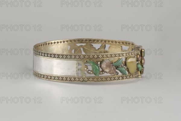 Headband, plant ornament, Chinese culture, Chinese art, Qing 1644–1911, head ornament, openwork inlaid with glass, semi-precious stones, river pearls and beads, 19th century, China, height 3.3 cm, diameter 12 cm, A decorative circular band with metallic surfaces in gold and silver tones sits on a pale gray background, featuring ornate edges with a repeating floral motif in gold along the top and bottom, a smooth silver-toned central panel, and an openwork interior in gold. A cluster of small three-dimensional leaf and fruit shapes in green, pale yellow, and muted brown is attached to one section, with additional small rounded bead-like accents in a pearly white nearby. The clasp area includes small rounded colored elements in green and pink set in gold, and the band displays subtle variations in sheen and surface texture across its metallic and enameled areas.