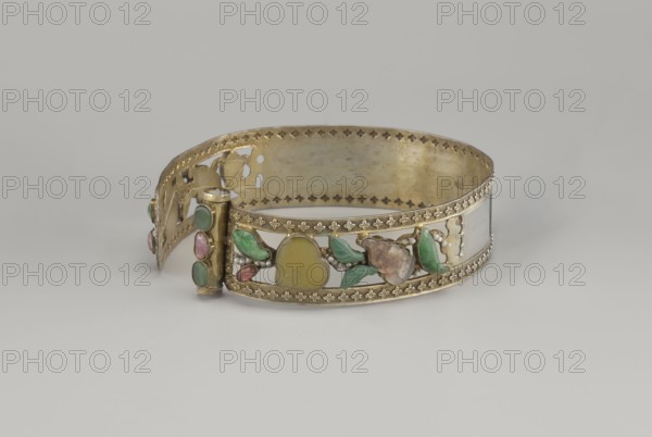 Headband, plant ornament, Chinese, Chinese art, Qing 1644–1911, head ornament, openwork inlaid with glass, semi-precious stones, river pearls and beads, 19th century, China, height 3.3 cm, diameter 12 cm., A decorative metal band with a hinged clasp lies against a pale gray background, the band showing a gold-toned finish with ornate pierced and stamped edging and an openwork central section set with decorative stones and enamel in organic shapes; visible colors include gold, green, pink, yellow, brown, and white, with glossy green leaf-shaped elements, a yellow rounded central piece, pink teardrop accents, small white bead-like details, and a brownish flower-like form, all arranged along the front panel of the band.