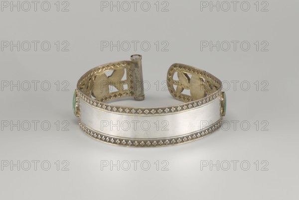 Headband, gift; plant ornament, Chinese, Chinese art; Qing dynasty 1644–1911, 19th century; openwork inlaid with glass, semi-precious stones, river pearls and beads; head ornament; height 3.3 cm, diameter 12 cm., A metallic cuff bracelet shown against a neutral background, featuring a wide central band of smooth silver-toned metal with decorative borders of small raised floral motifs in a gold-toned trim; the inner sides of the cuff display cut-out patterns in a gold color and a hinged cylindrical element at the back, and there are green oval stone settings at the ends.