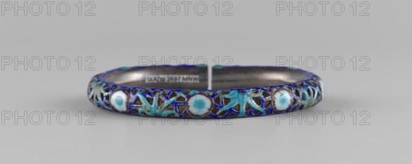 Bracelet, ornaments, Chinese art, Chinese culture, women's ornaments, Qing 1644–1911, 19th century, China, jewelry, diameter 11.0 cm, A circular cuff bracelet with an open gap, featuring a decorative outer surface of interlaced latticework and round enamelled motifs in shades of blue and turquoise, set against a metallic base that appears silver-gray; the enamel shows gradients of light blue and white within the round motifs and darker blue outlines, with the lattice areas containing turquoise floral-like shapes and darker blue accents, all resting on a neutral gray background.