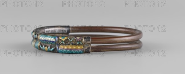 Bracelet, ornaments, Chinese art, Chinese culture, women's ornaments, Qing 1644–1911, plant ornament, enamel colors: white, yellow, teal, blue, 19th century, China, jewelry, diameter 7.0 cm, A double-loop bracelet composed of brown metal bands with a decorative metal section featuring inlaid enamel in turquoise, blue, yellow, purple, and green hues, set against a silvery base; the background is light gray.