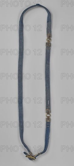 Bridle reins bridle fragment, maker, Chinese, Qing 1644–1911; cloisonné enamel on copper with leather ribbon and bronze fittings; decorated with fish motifs on a blue ground; horse tack riding equipment, length 86 cm; 18th century., A long fabric strap in shades of blue with a worn texture forms a loop, featuring metal fittings in a brass and darkened metal color at intervals and near the ends; the strap shows frayed edges and areas of lighter and darker blue wear, and a small cluster of metal hardware in brass and dark metal is attached at one end.