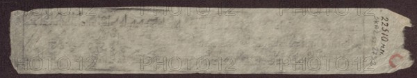 Page with Buddhist text, unknown author, Tibetan Buddhist art, Tibetan culture, Chinese culture, Chinese art, Buddhism, mantras, 19th century, China, Tibet, manuscript, height 17.5 cm, width 4.5 cm, A long, narrow strip of worn, translucent paper rests on a dark background; the paper has uneven, frayed edges and a torn corner, and its surface shows subtle creases and thin, fibrous texture. The paper appears mostly pale gray to off-white with areas of slightly darker gray shading and faint smudges. Along one end there is a small circular mark in a muted red color. The background behind the paper is a deep, dark brown to near-black.