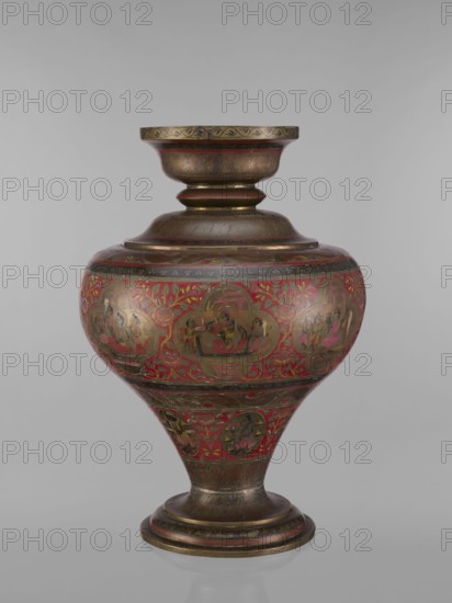 Vase, 19th century, India. Vase with a bulging, flattened belly tapering toward the bottom; wide spout and round foot. Polychrome in red, pink, yellow, white and black; decorated with jugs, gods Vishnu, Shiva, teachers, fish, plant and geometric ornaments, and figures associated with Hinduism Vaishnavism, Shaivism and ascetics. Vessel; height 50.0 cm, diameter 13.0 cm, weight 5.75 kg., A large ornamental vessel with a flared rim, a bulbous midsection, and a tapered base, decorated with intricate painted scenes within rounded panels and surrounded by floral motifs; the surface shows a combination of metallic bronze or brass tones with prominent red areas and touches of black and muted gold, along with small accents of pink and green; the vessel rests on a circular pedestal base and the neck and rim feature etched or engraved linear patterns and repeating leaf-like designs; the painted panels depict seated figures and groups in various poses, rendered in darker tones against the red back...
