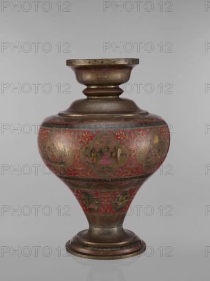 Vase, noted. Indian, 19th century. Vessel with a bulging, flattened belly tapering toward the bottom; wide spout and round foot. Polychrome in red, pink, yellow, white and black. Motifs include gods Vishnu, Shiva, teachers, fish, plant and geometric ornaments, ascetics; associated with Hinduism, Vaishnavism, Shaivism. Height 50.0 cm, diameter 13.0 cm, weight 5.75 kg., A rounded, ornate vessel with a flared rim and pedestal base sits against a plain background, showing a bulbous midsection that tapers to a narrow stem and circular foot; the surface features intricate decorative panels and floral motifs with a dominant red background and metallic areas that appear gold and bronze, along with accents of dark brown and small touches of pink and green, and the vessel displays a glossy finish with visible painted scenes and repeated patterned bands around the neck and base.