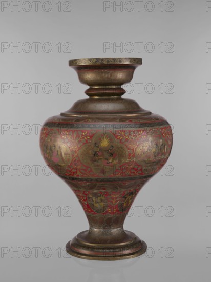 Vase. Vase with a bulging, flattened belly, tapering towards the bottom; with a wide spout and a round foot. Polychrome in the colours: red, pink, yellow, white and black. 19th century, India. Vessel. Height 50.0 cm, diameter 13.0 cm, weight 5.75 kg. Subjects and motifs: Indian art; Hinduism Vaishnavism, Shaivism; gods Vishnu, Shiva, teachers, ascetics; jugs, containers; fish; plant ornaments; geometric ornaments. Creator: unknown. ., A large decorative vessel sits upright against a neutral gray background, with a rounded body that tapers to a narrow foot and rises to a wide flaring neck. The surface shows intricate painted motifs and medallion scenes arranged around the body and lower section, with leafy and floral patterns filling the spaces between. The vessel displays a metallic sheen with visible gold tones and areas of dark bronze or brown patina, along with prominent red painted fields and touches of black. The neck and foot have banded ornamentation and engraved or incised foli...