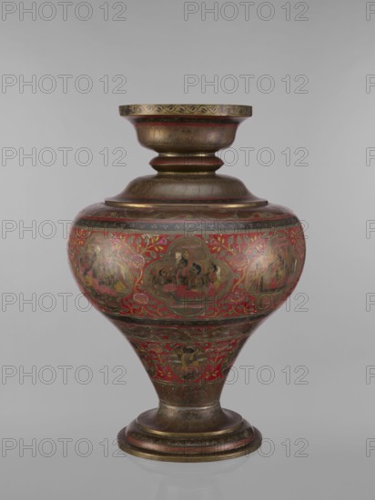 Vase, unknown creator; gift; Indian art; Indian, South Asian cultures; Hinduism, Vaishnavism, Shaivism; jugs, gods, containers, teachers; Vishnu, Shiva, fish, plant ornaments, geometric ornaments, ascetics. Vase with a bulging, flattened belly, tapering towards the bottom; with a wide spout and a round foot. Polychrome in red, pink, yellow, white and black. 19th century, India; vessel; height 50.0 cm, diameter 13.0 cm, weight 5.75 kg., A decorative vessel with a rounded body that tapers to a narrow base and rises to a flared neck, featuring a metallic surface with ornate painted scenes and patterns. The vessel displays a dominant red background with gold and bronze metallic areas and detailed painted figures and floral motifs in darker tones. There are a few round medallion-like panels around the body each containing small human figures, and several bands of repeating ornamental designs encircle the neck and base. The surface shows fine linework and leaf-like patterns in metallic gold ...