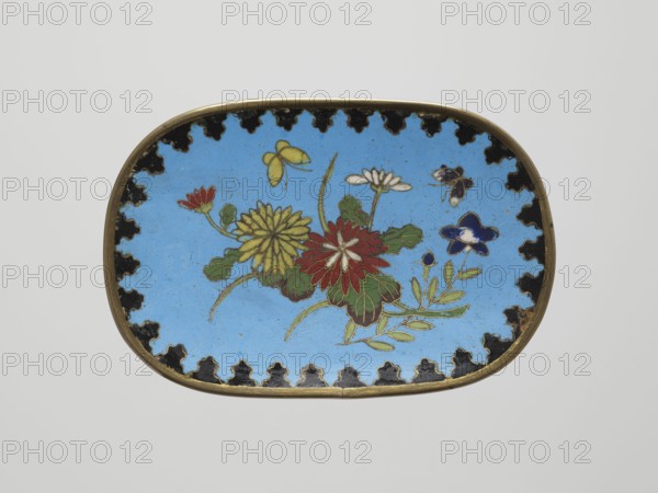 Tray, Japanese art, Japanese, Meiji 1868–1912, butterflies, flowers, chrysanthemums, 19th/20th century Meiji period, Japan, vessel; height 8.3 cm, width 12.3 cm, An oval decorative object with a thin metallic rim and a bright sky-blue interior field, featuring a central floral arrangement in red, yellow, green, white, and dark blue with leafy green stems and petals, accented by small stylized insects in yellow and dark blue; the blue interior is surrounded by a scalloped black border with repeating shapes, and the rim appears brass-colored.