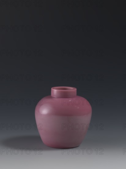 Ginger vessel, gift, Chinese, Qing 1644–1911, ovoid storage pot with a short collar, mid-19th century, China, vessel; height 11.5 cm, diameter 11.5 cm, weight 0.46 kg., A rounded ceramic vase with a short cylindrical neck sits on a flat surface, showing a smooth glossy finish and a uniform purple-pink color; the background is a gradient of dark gray and near-black tones and there is a soft shadow in darker gray beneath and to one side of the vase.