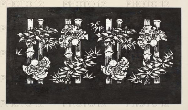 Katagami dyeing stencil with a motif of bamboos and bulging sparrows take ni fukura suzume, ise-katagami stencil, chuban format, bamboos and sparrows motif, stencil; Meiji period, 2nd half of the 19th century 1868–1912, Japan; height 40.1 cm, width 23.8 cm., A dark rectangular artwork framed by a light beige border shows a repeating pattern of vertical bamboo stalks and stylized floral and leafy clusters cut out in white; the background is mostly black with subtle dark blue and gray textured variations, while the white cutouts form groupings of rounded flower shapes, radiating petals, long narrow leaves, and segmented bamboo columns with occasional dripping or fringe-like details.