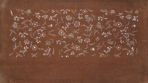 Katagami dyeing stencil with a motif of scattered pine needles and flowers matsuba chirashi ni hana moyô, ise-katagami stencil, chuban format; plant pattern of pine needles and flowers; 19th century Edo period, Japan; stencil; height 41.3 cm, width 24.9 cm;, A large rectangular surface with a worn brown background showing a horizontal band near the top filled with a delicate pattern of white floral shapes and leaf-like strokes, the rest of the surface mostly unadorned brown with subtle texture and slight discoloration along the edges.